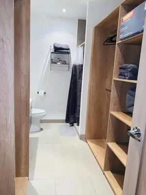 a bathroom with a toilet and a closet at APARTAMENTO CON LA MEJOR VISTA DE SAN SALVADOR in San Salvador