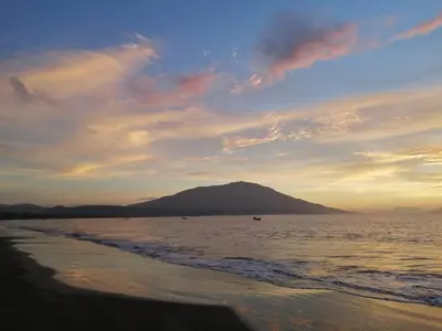 a view of the ocean with a mountain in the background at La Ceja Beach House in El Tamarindo