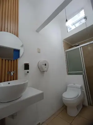 a white bathroom with a sink and a toilet at El Patio de Don Moncho in Nueva San Salvador