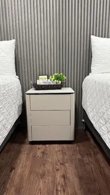 a nightstand with a plant on it next to two beds at Villa Las Flores in San Salvador