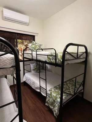 a room with two bunk beds and a window at Villa Las Flores in San Salvador