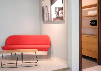 a red couch and a table in a room at Il Buongustaio in San Salvador