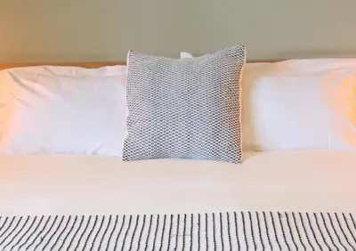 a white bed with a pillow on top of it at Il Buongustaio in San Salvador