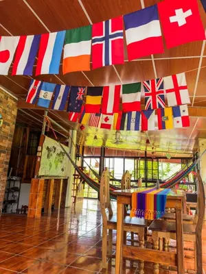 a room with a table with flags on the wall at Hostal Raíces de mi Pueblo in Suchitoto
