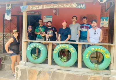 a group of people posing for a picture in a building at Hostal Raíces de mi Pueblo in Suchitoto