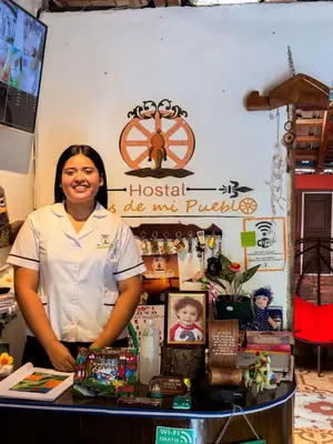 a woman standing behind a counter in a store at Hostal Raíces de mi Pueblo in Suchitoto