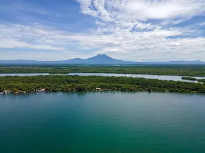 an aerial view of a lake with a mountain in the background at Hotel Bahia del Sol in La Herradura