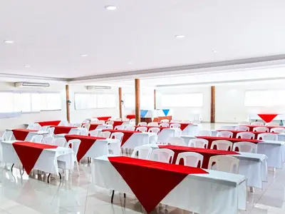 a room with red and white tables and chairs at Hotel Bahia del Sol in La Herradura