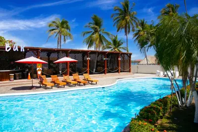 a resort swimming pool with chairs and umbrellas at Hotel Bahia del Sol in La Herradura