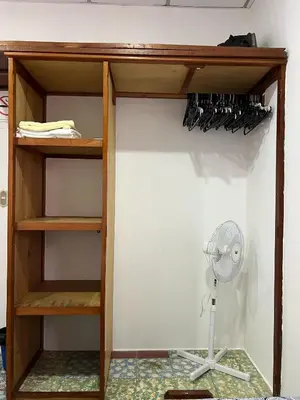 a closet with a fan and a shelf with wine glasses at Mixtepek in Juayúa