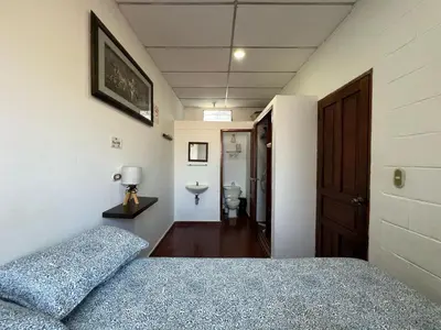 a bedroom with a bed and a bathroom at Mixtepek in Juayúa