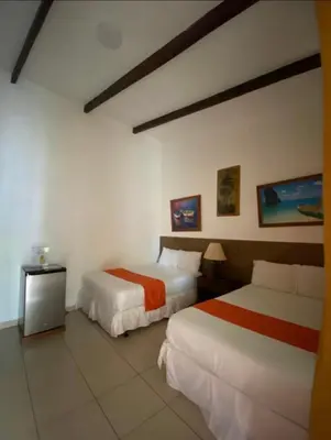 a hotel room with two beds and a table at Konchamar in La Libertad