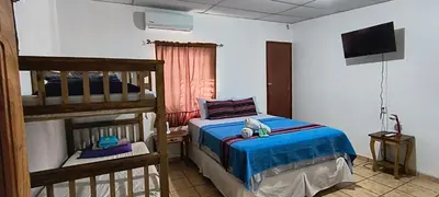 a bedroom with a bunk bed with a teddy bear sitting on the bed at Nanda Parbat Hostal in San Rafael Cedros