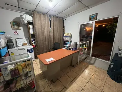 an office with a desk and a refrigerator at Nanda Parbat Hostal in San Rafael Cedros