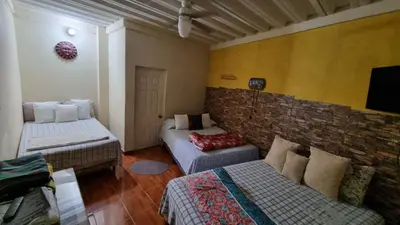 a living room with two beds and a couch at Hostal Las Veraneras Ataco in Concepción de Ataco