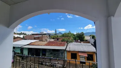 an archway view of a city from a building at Hostal Las Veraneras Ataco in Concepción de Ataco