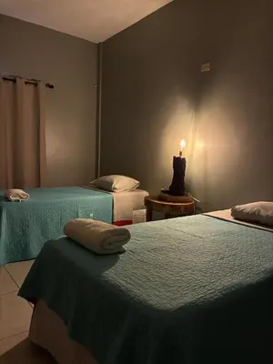 a room with two beds and a lamp on a table at RodMar Hotel in El Cuco
