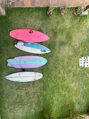 a group of three surfboards sitting on the grass at RodMar Hotel in El Cuco