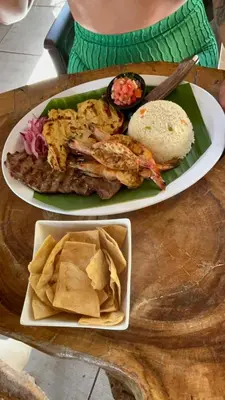 a plate of food with fish and chips and chips at RodMar Hotel in El Cuco