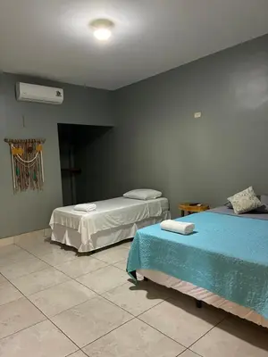a bedroom with two beds and a fan at RodMar Hotel in El Cuco