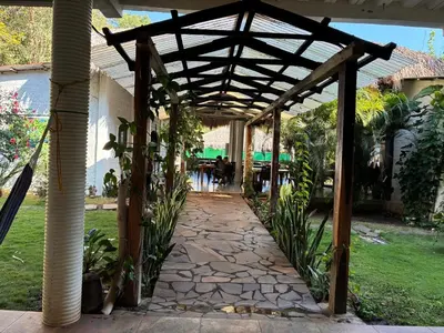 a wooden pergola with a walkway in a yard at RodMar Hotel in El Cuco
