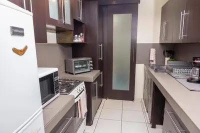 a kitchen with a stove and a microwave at Luxury Modrn Apartment, w/amazing view, 3BR,Escalon,Exclus,Secur in San Salvador