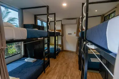 a room with four bunk beds in a bus at Lagarza Hostel in La Libertad