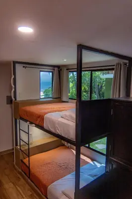 a bedroom with two bunk beds and a window at Lagarza Hostel in La Libertad