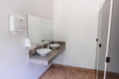 a bathroom with two sinks and a mirror at Lagarza Hostel in La Libertad