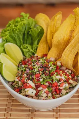 a bowl of salad with corn chips and vegetables at Lagarza Hostel in La Libertad