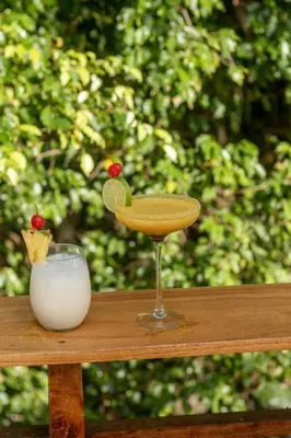 a drink in a glass next to a bowl of milk at Lagarza Hostel in La Libertad