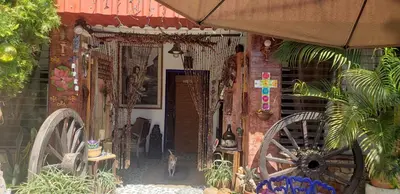 a house with two largeokedoked wheels and a building at Mendoza’s Guest House in Santa Ana