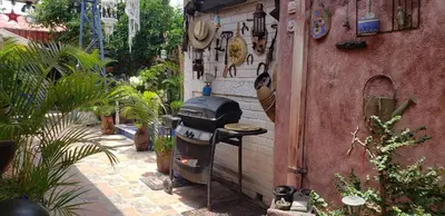 a grill in the side of a building with plants at Mendoza’s Guest House in Santa Ana