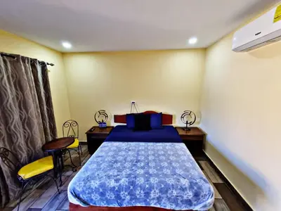 a bedroom with a bed and a table and chairs at Hostal Juarez Ataco in Concepción de Ataco