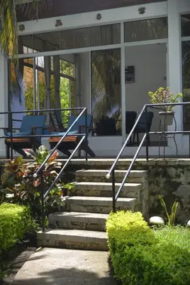 a set of stairs in front of a house at RocaSol Casa d´Mar in El Zonte