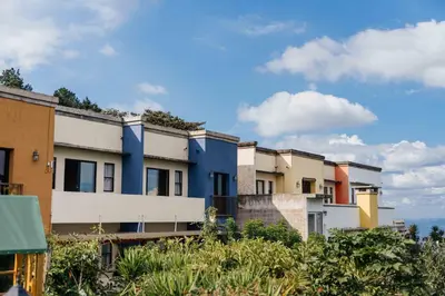 a row of apartment buildings on a hill at Casa 1800 Ataco Hotel Boutique in Concepción de Ataco