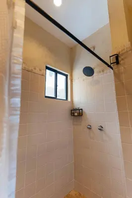 a bathroom with a shower with a window at Casa 1800 Ataco Hotel Boutique in Concepción de Ataco