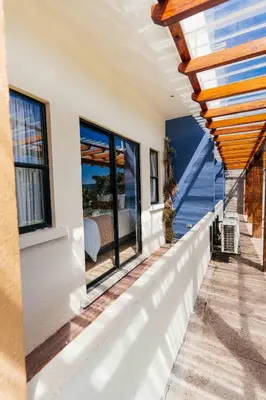 a house with a balcony with a view of the ocean at Casa 1800 Ataco Hotel Boutique in Concepción de Ataco