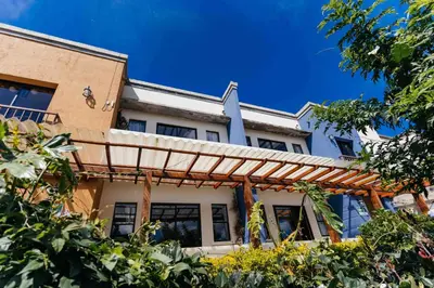 an exterior view of a house with a pergola at Casa 1800 Ataco Hotel Boutique in Concepción de Ataco