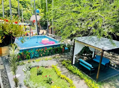 a backyard with a swimming pool and a swing at The Beach Break Hotel El Zonte in El Zonte