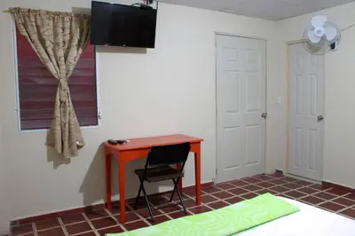 a room with a desk and a chair and a window at Casa Central completa in Santa Ana