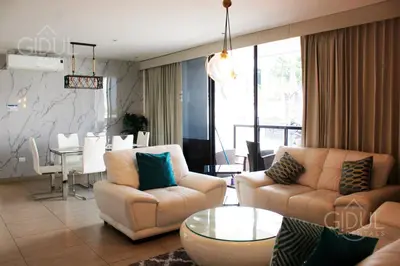 a living room with two couches and a dining room at The Luxury Apartment in San Salvador