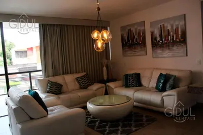 a living room with couches and a coffee table at The Luxury Apartment in San Salvador