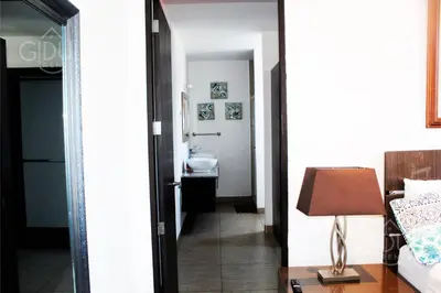 a room with a bathroom with a sink and a mirror at The Luxury Apartment in San Salvador