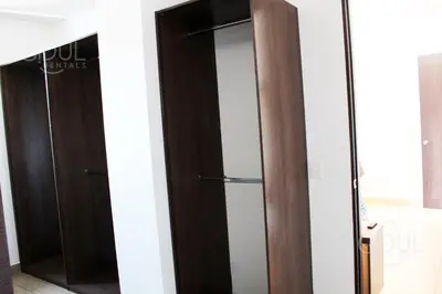 a closet with two wooden elevators in a room at The Luxury Apartment in San Salvador