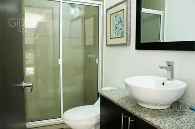 a bathroom with a toilet and a sink and a shower at The Luxury Apartment in San Salvador