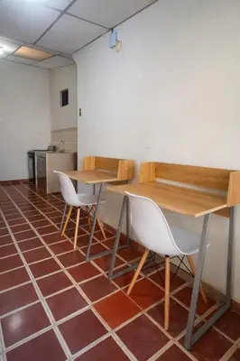 a room with two tables and chairs on a tile floor at Casa Central de Santa Ana in Santa Ana