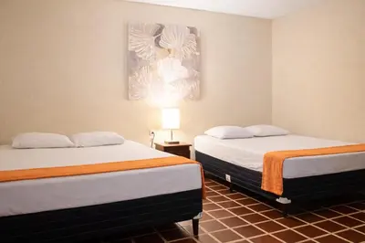 a room with two beds and a painting on the wall at Casa Central de Santa Ana in Santa Ana