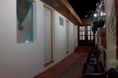 a hallway with chairs and a door with a window at Casa Central de Santa Ana in Santa Ana