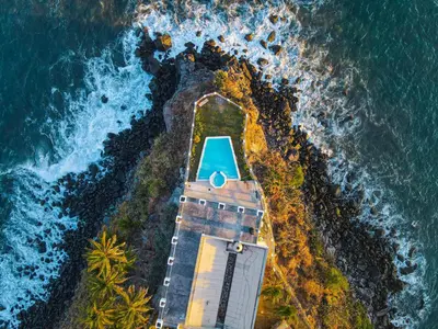 an aerial view of a boat on the ocean at Paradise Surf Hotel in San Miguel